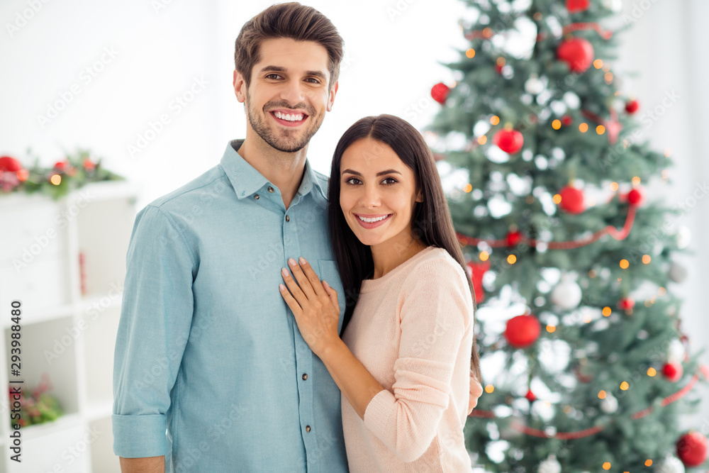 Portrait of two people charming romantic sweethearts hug near christmas tree enjoy x-mas holidays in house indoors