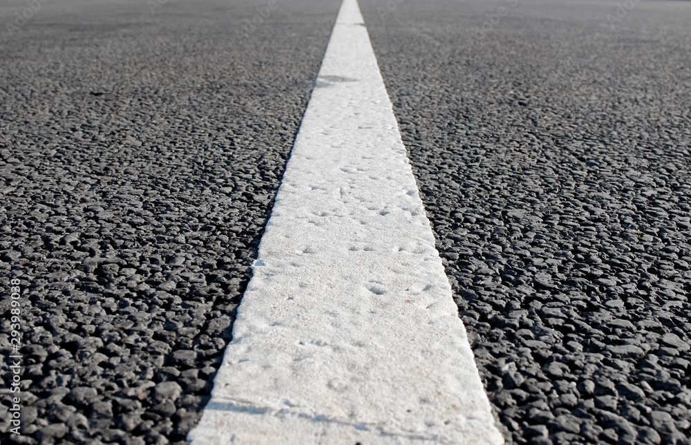 Obraz premium An empty road with single solid white line road marking. Background photo in perspective with selective focus