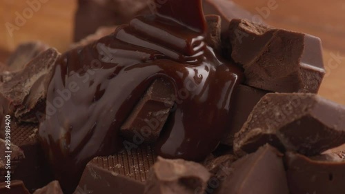 Melted chocolate pouring over chunks of chocolate