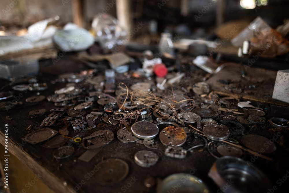 Old watch mechanisms / parts on table Old watch mechanisms / parts on table