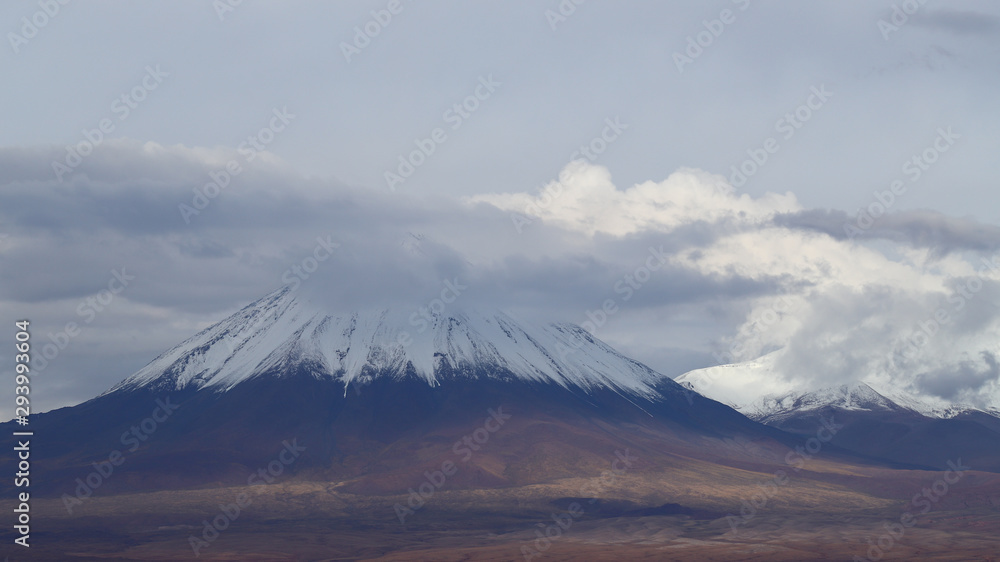 View of the Licancabur volcano covered by clouds and snow, Atacama Desert, Chile