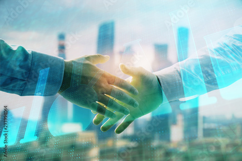 Double exposure of chemistry theme hologram on city view background with handshake. Concept of education photo