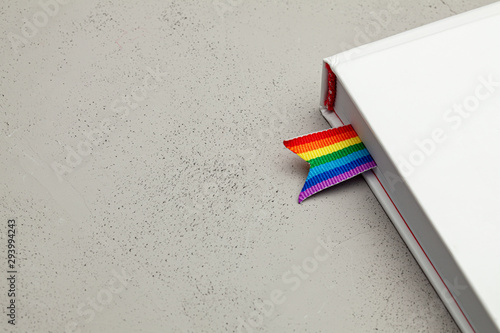 Book with bookmark and rainbow ribbon of LGBT pride photo