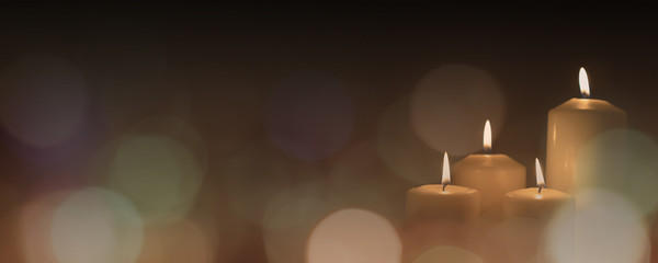 Christmas advent candle light in church with blurry golden bokeh for religious ritual or spiritual zen meditation, peaceful mind and soul, or funeral ceremony