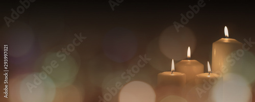Christmas advent candle light in church with blurry golden bokeh for religious ritual or spiritual zen meditation, peaceful mind and soul, or funeral ceremony