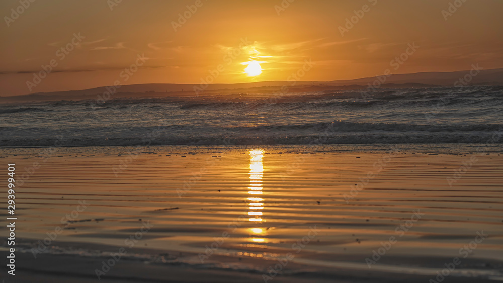 Orange sunset over Enniscrone Beach, Ireland.