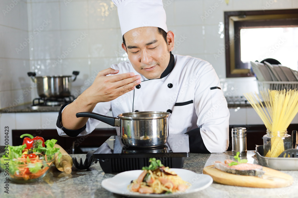 Asian Man Chef cooking food  in restuarant