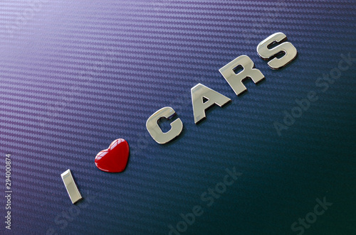 Concept of love of cars, motoracing. Letters on carbon fiber background