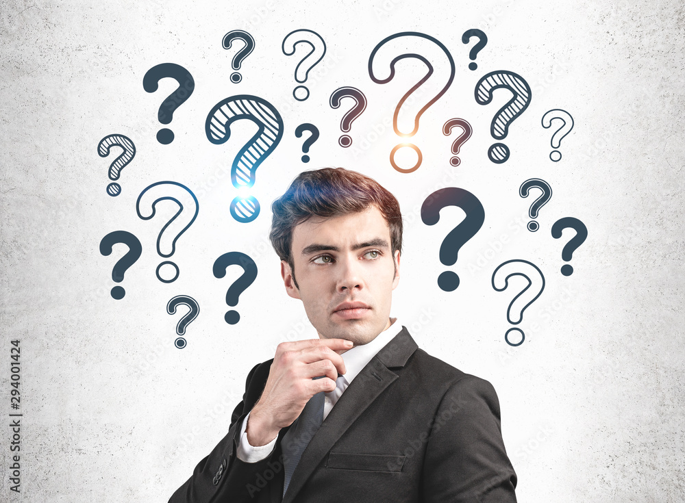 Thoughtful businessman and question marks Thoughtful businessman and question marks