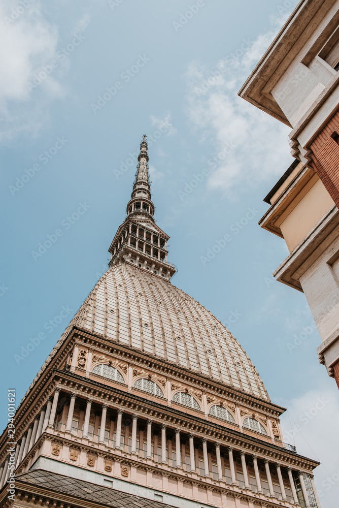 Scenic view on Mole Antonelliana. Major landmark building in Turin. National Museum of Cinema. Old architecture. Italian history. Bottom view, close up. Travel to Piemonte, Italy. Europe adventure
