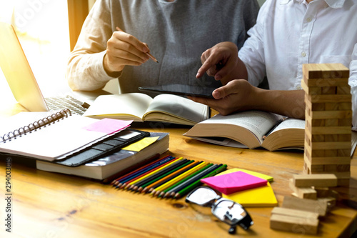 Students helps friend teaching and learning subject additional in library. using laptop to the education . education concept.