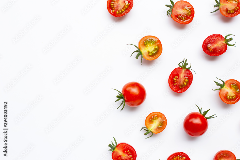 Fototapeta premium Fresh tomatoes, whole and half cut isolated on white background.