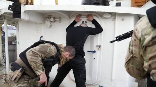 Special forces search terrorist on deck of vessel.