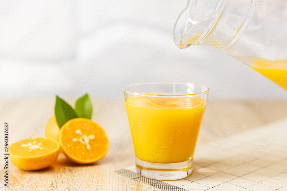 Close up Pour oranges juice into the glass on the table wooden. fruit fruits drink Close up Pour oranges juice into the glass on the table wooden. fruit fruits drink