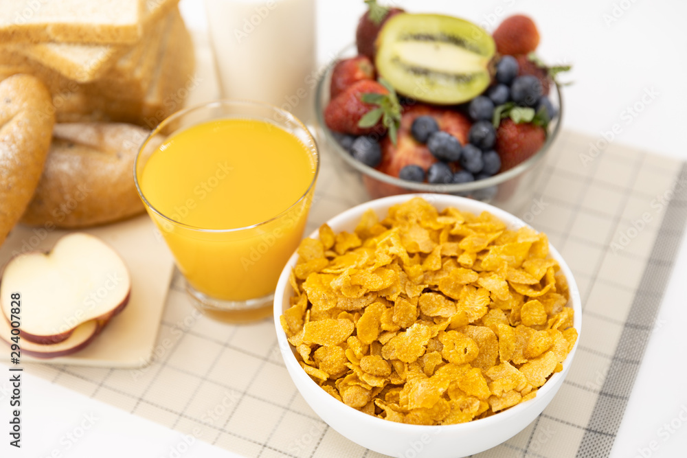 Healthy breakfast. bread, orange juice, strawberry, blueberries, kiwi, milk and cereal in bowl on mat background. Healthy food Healthy breakfast. bread, orange juice, strawberry, blueberries, kiwi, milk and cereal in bowl on mat background. Healthy food