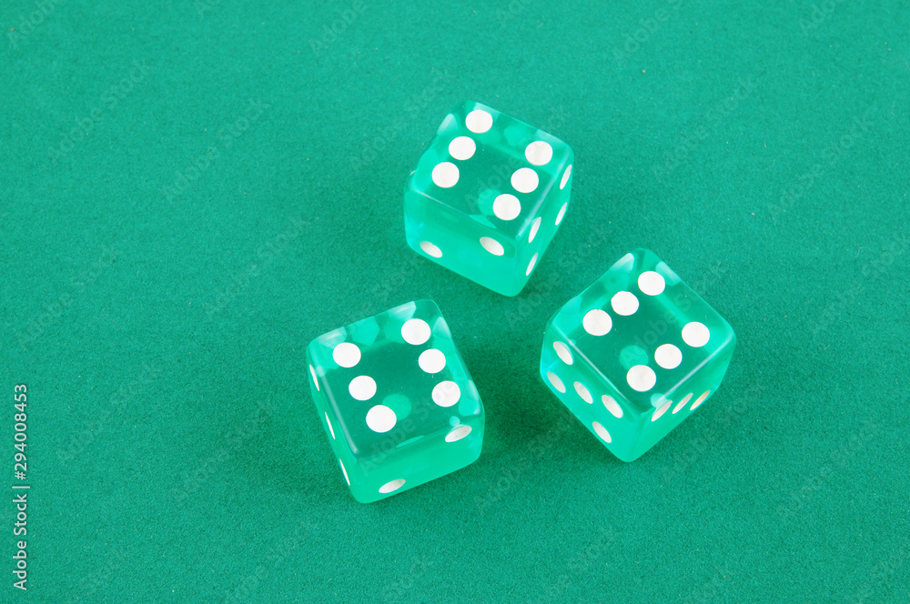 Three dices on green gaming table, gambling concept Three dices on green gaming table, gambling concept
