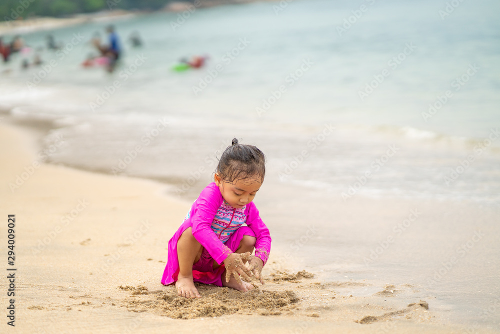 Little asian girl playing on the beach.Vacation and relax concept. Little asian girl playing on the beach.Vacation and relax concept.