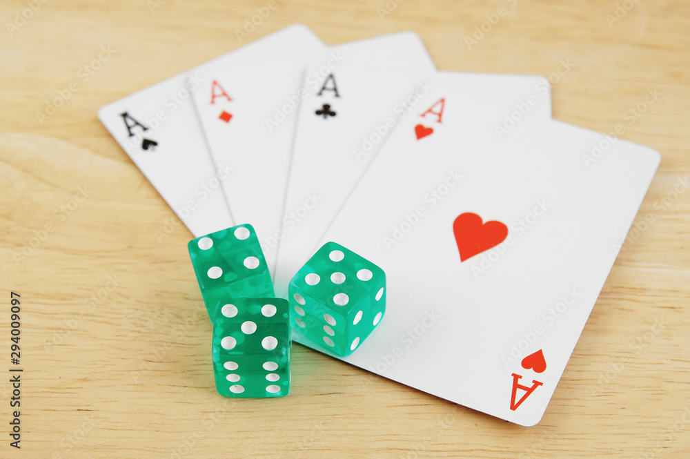 Dices and cards on wooden table, gambling concept