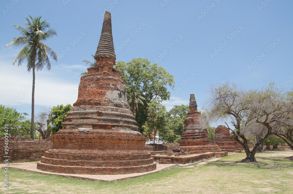 Asian religious architecture. Ancient pagoda at Wat Phra Sri Sanphet temple under blue sky. Ayutthaya, Thailand Asian religious architecture. Ancient pagoda at Wat Phra Sri Sanphet temple under blue sky. Ayutthaya, Thailand