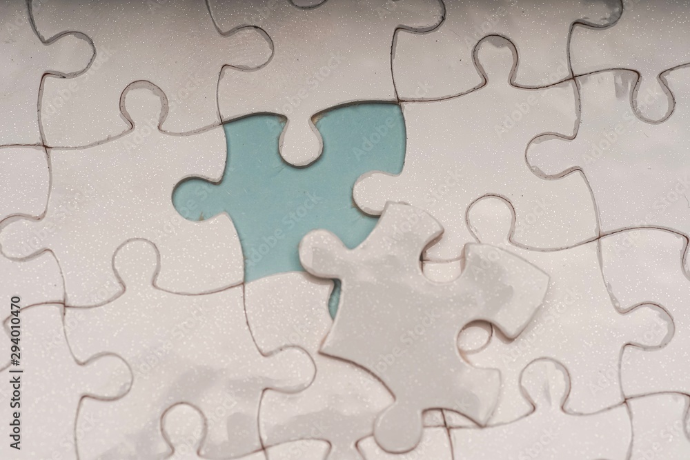 Closed up shot of blank white puzzle pieces, selective focus, copy space for text Closed up shot of blank white puzzle pieces, selective focus, copy space for text