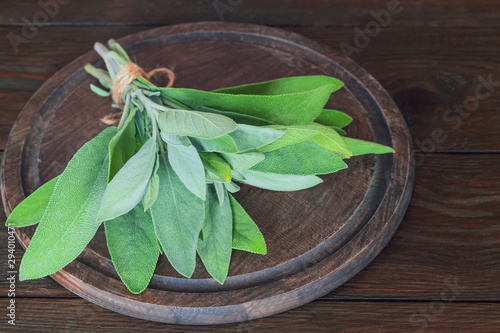 fresh sage. a bunch of fragrant medicinal sage on a chopping board closeup. background with fresh green sage.