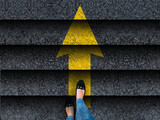  woman legs in shoes climbing stairs with arrow. business. success or progress concept