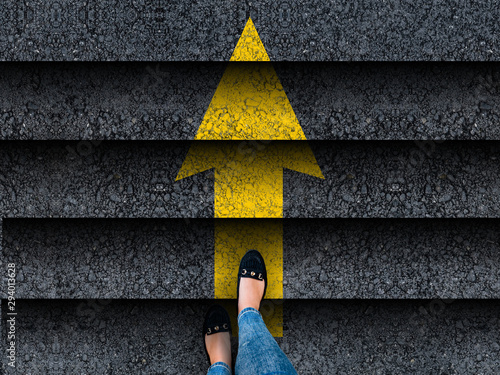  woman legs in shoes climbing stairs with arrow. business. success or progress concept