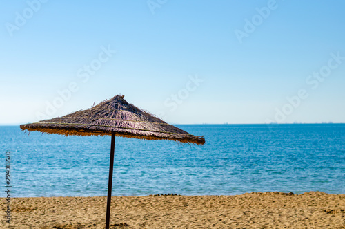 Canopy of straw in the form of an umbrella in the summer on the beach.