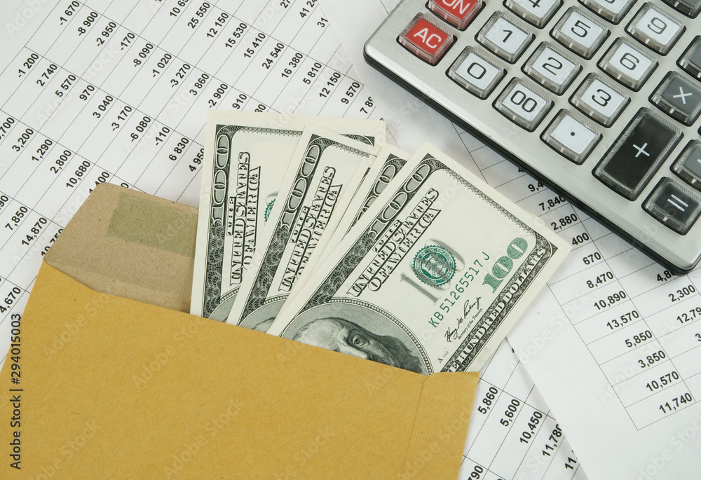 Business and profits concept with calculator, money in envelope and documents Business and profits concept with calculator, money in envelope and documents