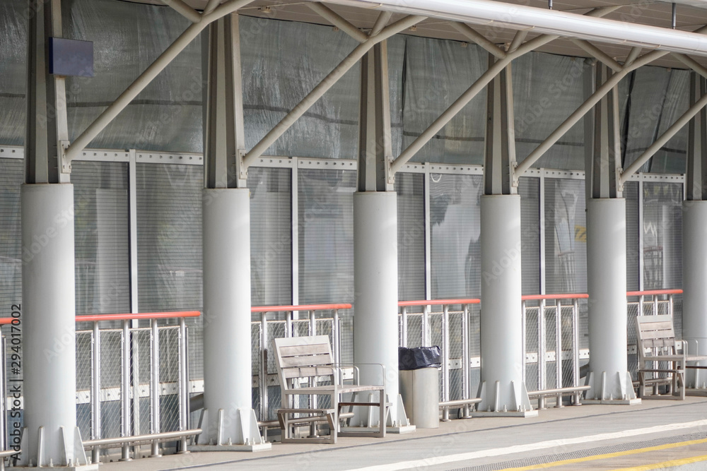 Fototapeta premium canopy over the bus stop from rain and sun, a bench to wait for a train or train. long distance moving