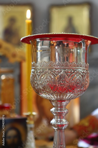 Orthodox churches. A silver cup for communion, a prosphora for the preparation of the sacred mystery of the Eucharist, and sweet wine on the table on the throne. photo