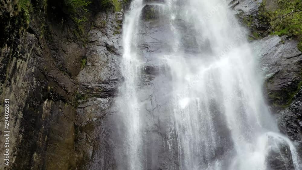 Natural waterfall pouring down the rocks real time up/down tracking view 4K Natural waterfall pouring down the rocks real time up/down tracking view 4K