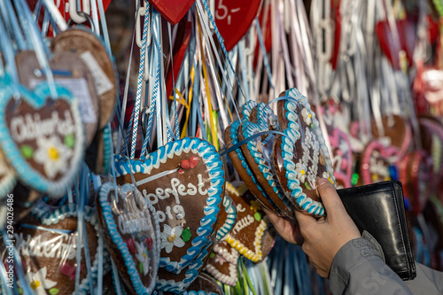 hands of a women on a typical gingerbread hearts at the oktoberfest in munich 2019 with the word Oktoberfest 2019 on it