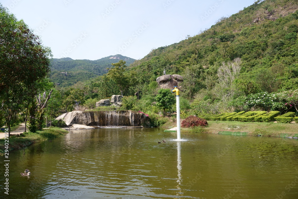 Obraz premium Vietnam - May 2019. Lake with ducks, waterfall and fountain on 