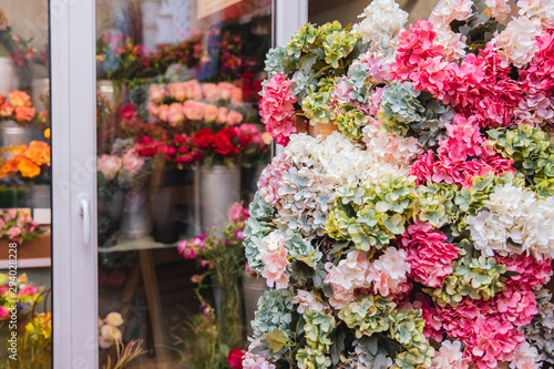 Banner florist shop, closeup luxurious flowers bouquet, in background fridge storage