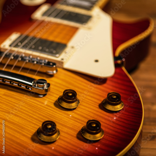 Photography electric guitar body close-up view is on the wood floor