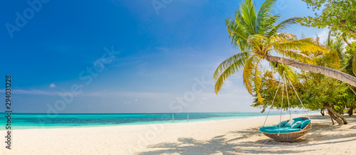 Fototapeta Naklejka Na Ścianę i Meble -  Tropical beach panorama as summer landscape with beach swing or hammock and white sand and calm sea for beach banner. Perfect beach scene vacation and summer holiday concept. Boost up color process
