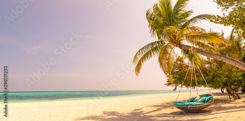 Fototapeta Naklejka Na Ścianę i Meble -  Tropical beach panorama sunset, summer landscape with beach swing or hammock and white sand and calm sea for beach banner. Perfect beach scene vacation and summer holiday concept