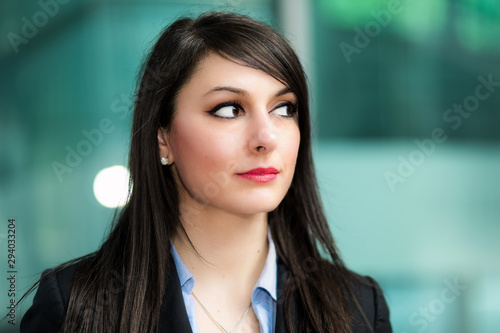 Smiling businesswoman poirtrait in a pensive expression