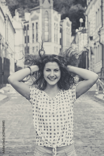 Obraz na płótnie Young pretty girl walking down the street at sunshine w salonie