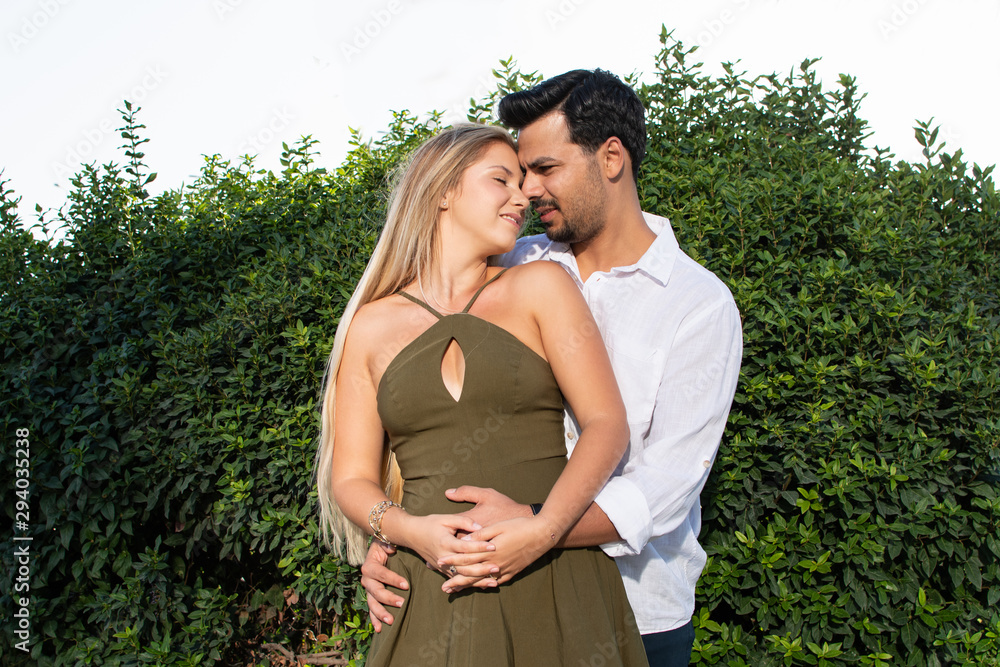Romantic in-love and happy mixed race couple. Caucasian blonde woman and Turkish (Middle Eastern) man in love. Romantic lovers on vacation. Honeymoon in Turkey. Standing and holding hands. Eyes closed Romantic in-love and happy mixed race couple. Caucasian blonde woman and Turkish (Middle Eastern) man in love. Romantic lovers on vacation. Honeymoon in Turkey. Standing and holding hands. Eyes closed