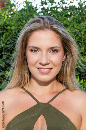 Beauty Woman Portrait. Closeup Of Beautiful Happy Girl With Perfect Smile,  Smiling At Camera. Green eyes. Attractive Healthy Young Female With Fresh Natural Face Makeup Outdoors. 20 to 25 year old.
