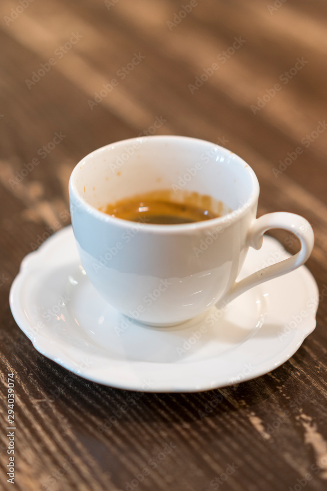 Cup of coffee with foam on wooden table, top view. A cup of coffee on wooden background. vertical photo Cup of coffee with foam on wooden table, top view. A cup of coffee on wooden background. vertical photo