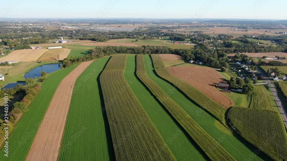 Aerial view of corn and alfalfa hay fields in Lancaster County, Pennsylvania, high aerial, parallax, pan right Aerial view of corn and alfalfa hay fields in Lancaster County, Pennsylvania, high aerial, parallax, pan right