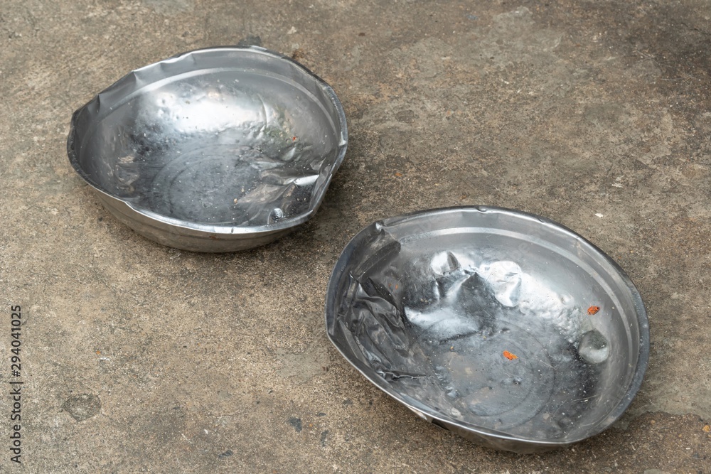 an old used stainless steel dog's food bowl an old used stainless steel dog's food bowl