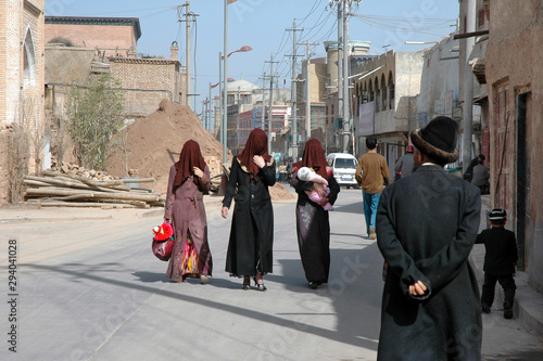 Three Uyghur Madonnas on the street of old town. Kashgar, Xinjiang, China, Asia. photo