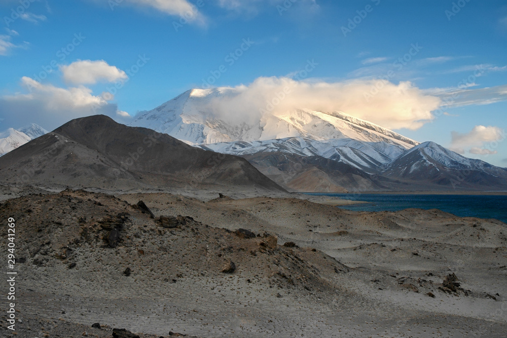 Mountainous landscape. View at Muztagh Ata Peak (7546 m) and Karakul Lake. Pamir mountains, outskirts of Kashgar, Xinjiang, China, Asia.
