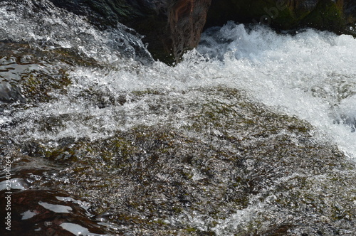 water flowing over rocks © Subhashisa