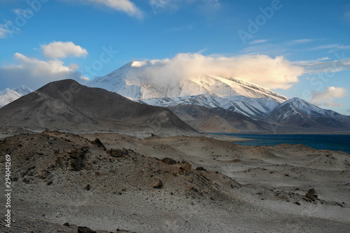 Mountainous landscape. View at Muztagh Ata Peak (7546 m) and Karakul Lake. Pamir mountains, outskirts of Kashgar, Xinjiang, China, Asia.