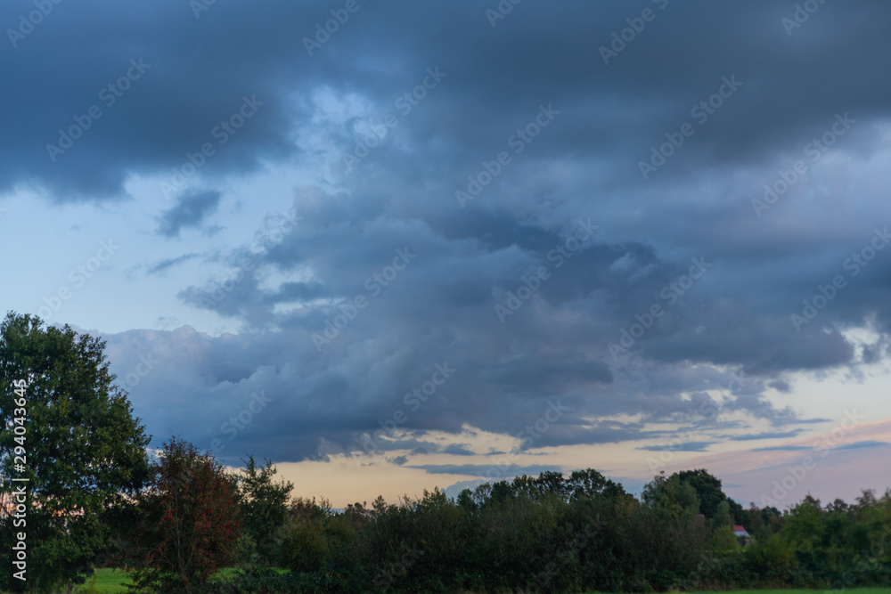 threatening cloud formations in the sky from the coming storm, while the blue of the sky is still visible threatening cloud formations in the sky from the coming storm, while the blue of the sky is still visible